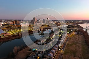 A stunning aerial shot of the skyscrapers, lights and buildings in the cityscape along the Mississippi river at sunset