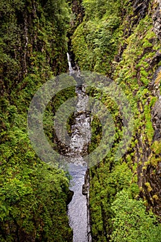 Stunning aerial view of the lush green canyon of Corrieshalloch Gorge in Scotland