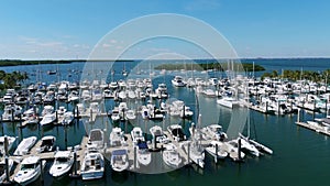 Stunning aerial view of luxury yachts and motorboats docked in spectecular Crandon Marina in Florida. Rich luxury water