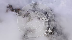 Stunning aerial view of a mountain gorge with swirling clouds