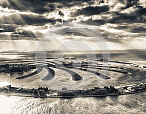Stunning aerial view of Palm Jumeirah at sunset with sun rays on