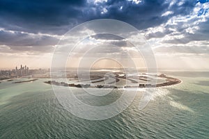 Stunning aerial view of Palm Jumeirah at sunset with sun rays on