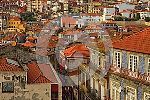 Stunning aerial view of traditional historic buildings in Porto. Vintage houses with red tile roofs.