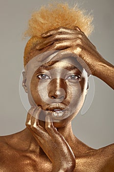 Stunning African Amercian Woman Painted With Gold photo
