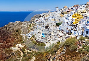 Stunning, amazing and beautiful classic white and caramel color Greek architecture with unbelievable wind mills on Santorini volca