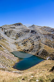 Stunning ariel view of the Lagh de Calvaresc lake with heart shape, in Swiss Alps, on the hiking path of Sentiero Calanca, on a photo