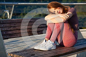 Stunning athletic ginger woman having break after training