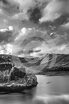 Stunning Autumn Fall landscape of Hawes Water with epic lighting and dramatic sunlight in Lake District