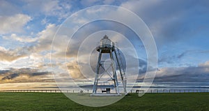 Stunning Autumn sunset landscape image of Sillloth lighthouse with Dumfries and Galloway mountains in distance