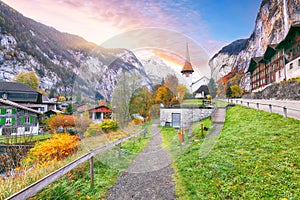 Stunning autumn view of Lauterbrunnen village with awasome Staubbach waterfall and Swiss Alps in the background