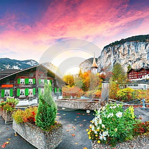 Stunning autumn view of Lauterbrunnen village with awesome waterfall  Staubbach  and Swiss Alps in the background