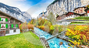 Stunning autumn view of Lauterbrunnen village with awesome waterfall  Staubbach  and Swiss Alps in the background