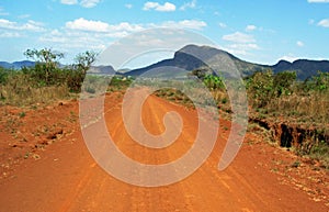 Stunning background landscape driving red dusty dirt roads of Africa