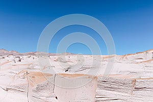 Stunning barren area in a white desert with volcanic rock formations in Campo De Piedra Pomez photo
