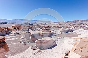 Stunning barren area in a white desert with volcanic rock formations in Campo De Piedra Pomez photo