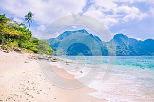 Stunning beach on Helicopter Island in the Bacuit archipelago in El Nido, Cadlao Island in Background, Palawan