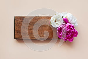 Stunning beautiful pink and white peonies, wooden Board on a light background. the view from the top