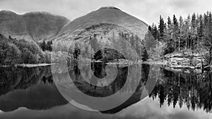 Stunning  black and white landscape image of Torren Lochan in Glencoe in Scottish Highlands on a Winter day