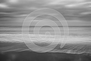 Stunning black and white long exposure landscape image of low ti