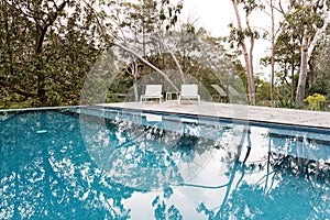 Stunning blue tiled infinity swimming pool in Australian bush se