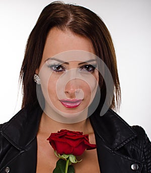 Stunning brunette holding a red rose