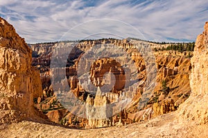 The stunning Bryce Canyon in all its glory taken from between two sandstone hoodoos with more amazing hoodoos in the distance with