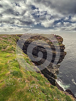 Stunning cliff in county Clare, Ireland, Loop head area. Dramatic cloudy sky. Irish landscape. Popular travel and nature