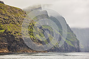 Stunning cliffs in Faroe islands coastline. Vestmanna boat trip photo