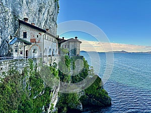 Stunning Cliffside View of Santa Caterina del Sasso Hermitage Overlooking the Calm Waters of Lake Maggiore photo