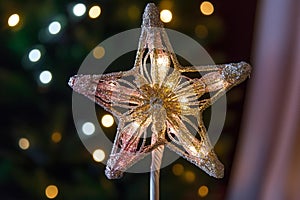 Golden Star Tree Topper Shines Bright on Christmas Tree at Night