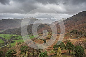 Stunning colorful Autumn landscape image of view from Castle Crag towards High Stile and Glaramara in Lake District