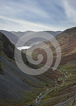 Stunning colorful landscape image of view down Honister Pass to Buttermere from Dale Head in Lake District during Autumn sunset