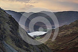 Stunning colorful landscape image of view down Honister Pass to Buttermere from Dale Head in Lake District during Autumn sunset