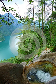 Stunning colorful waterfall falling to Konigsee known as Germany`s deepest and cleanest lake, located in Berchtesgadener National