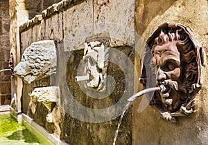 Stunning detail of the Fountain of the Seven Spouts, Pitigliano historical center, Tuscany, Italy