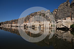 Stunning Devonian limestone cliffs of Geikie Gorge reflected in the Fitzroy River