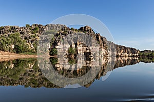 Stunning Devonian limestone cliffs of Geikie Gorge reflected in the Fitzroy River