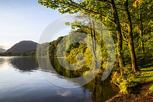 Stunning epic sunrise landscape image looking along Loweswater towards wonderful light on Grasmoor and Mellbreak mountains in Lkae photo