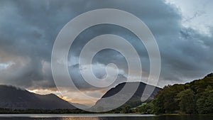 Stunning epic sunrise landscape image looking along Loweswater towards wonderful light on Grasmoor and Mellbreak mountains in Lkae photo