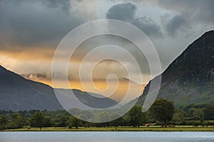 Stunning epic sunrise landscape image looking along Loweswater towards wonderful light on Grasmoor and Mellbreak mountains in Lkae photo