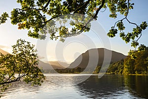 Stunning epic sunrise landscape image looking along Loweswater towards wonderful light on Grasmoor and Mellbreak mountains in Lkae photo