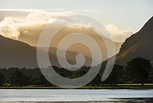 Stunning epic sunrise landscape image looking along Loweswater towards wonderful light on Grasmoor and Mellbreak mountains in Lkae photo