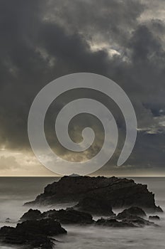 Stunning fine art landscape image of view from Hartland Quay in Devon England durinbg moody Spring sunset