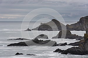 Stunning fine art landscape image of view from Hartland Quay in Devon England durinbg moody Spring sunset