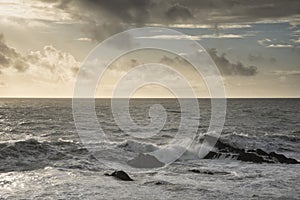 Stunning fine art landscape image of view from Hartland Quay in Devon England durinbg moody Spring sunset