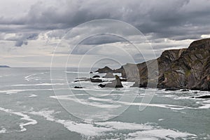 Stunning fine art landscape image of view from Hartland Quay in Devon England durinbg moody Spring sunset