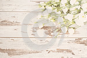 Stunning fresh bouquet of white flowers on light rustic wooden background. Copy space, floral frame. Wedding, gift card, valentine