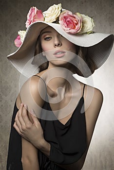 Stunning girl with flowers on hat