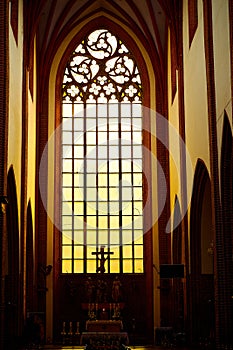 Stunning gorgeous sunset light through an old medieval Gothic church window in Europe.