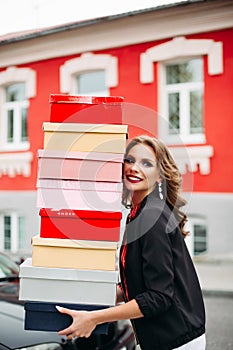 Stunning lady with stack of shoe boxes.